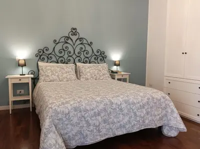 a bedroom with a large bed and two night stands at Your Place in Trastevere in Rome
