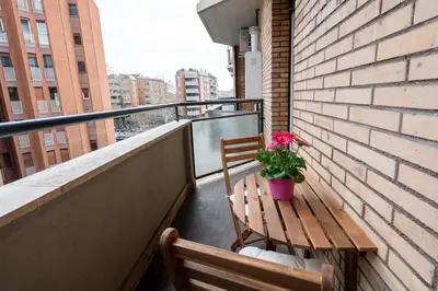 a balcony with a wooden bench and a potted plant at Your Place in Trastevere in Rome