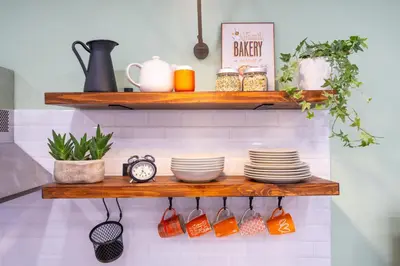 a wooden shelf with dishes and a clock on it at Your Place in Trastevere in Rome