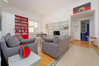 a living room with two couches and a table at Parioli, Bright And Quiet 2BR Apartment By Halldis in Rome