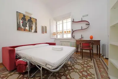 a bedroom with a bed and a table and a desk at Parioli, Bright And Quiet 2BR Apartment By Halldis in Rome