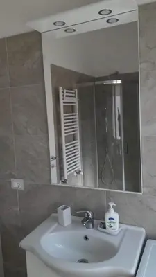 a bathroom with a sink and a mirror at ISABEL Apartment in Rome