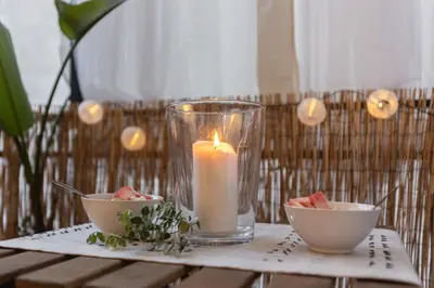a candle on a table with two bowls of watermelon at Casa Margherita in Rome