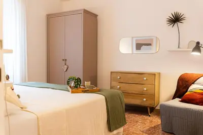 a bedroom with a bed and a dresser at Casa Margherita in Rome