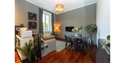 a living room with a table and a dining room at CupolHome - Meraviglia A San Pietro in Rome