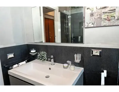 a bathroom with a white sink and a mirror at CupolHome - Meraviglia A San Pietro in Rome