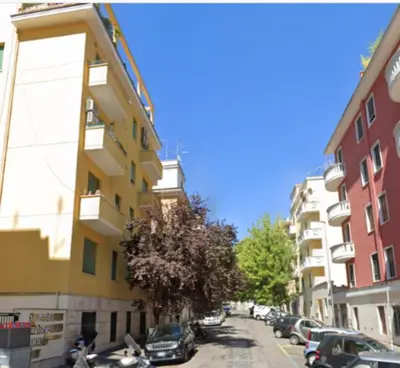 a city street with cars parked next to buildings at Domus Mariposa in Rome