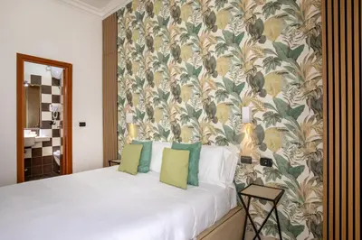 a bedroom with a bed and a desk and a television at Ciao Collection in Rome
