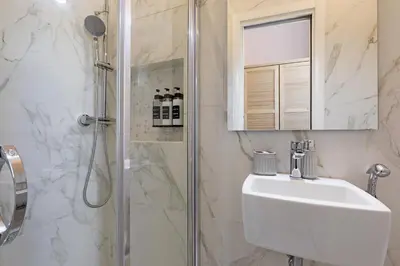 a bathroom with a sink and a shower at Zelo Apartment by Nosdom Properties in Rome