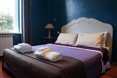a bedroom with a bed with towels on it at A Casa Di Elle in Rome