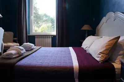 a bedroom with a large bed with a window at A Casa Di Elle in Rome