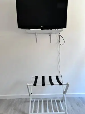a tv sitting on top of a stand with a television at Maison Monferrato in Rome