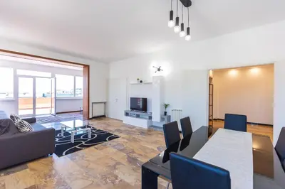 a living room with a table and a dining room at Baldo by Rental in Rome in Rome