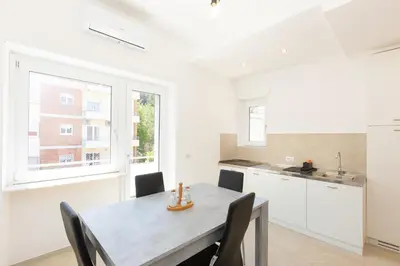 a kitchen and dining room with a table and chairs at Baldo by Rental in Rome in Rome