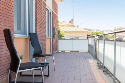 a balcony with two chairs and a window at Baldo by Rental in Rome in Rome