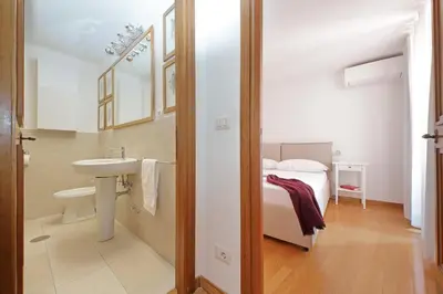 a small bathroom with a sink and a toilet at Via dell'Orso Charme - My Extra Home in Rome