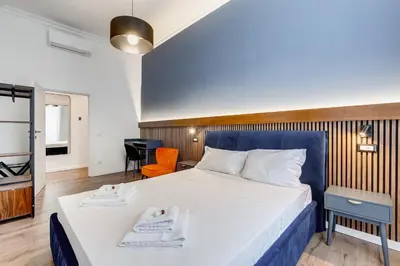 a bedroom with a large bed with two towels at BMGA l Ottaviano Lux 3Bdr Apartment in Rome