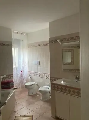a bathroom with a toilet and a sink and a tub at Bellissimo Appartamento- metro Battistini - Vaticano - 120mq in Rome