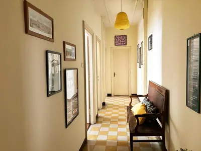 a hallway with a couch and pictures on the walls at Appartamento tipico Romano - Rione XXII Apartment in Rome