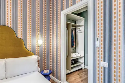 a bedroom with a mirror next to a bed at Townhouse Condotti 29 in Rome