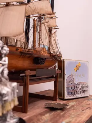 a model of a ship is next to a box at ConTe Green House - 2 Apartments in Rome