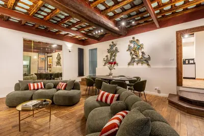 a living room with couches and a fireplace at ROMAC Baullari IV Large apartment in Campo de' Fiori in Rome