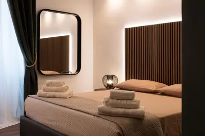 a bedroom with a bed with towels on it at Cavalieri Suites Roma in Rome