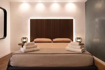 a bedroom with a bed with towels on it at Cavalieri Suites Roma in Rome