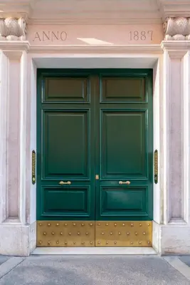 a green door on the side of a building at Cavalieri Suites Roma in Rome