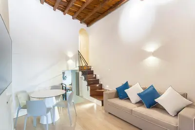 a living room with a couch and a table at Ciambella Atmosphere by Rental in Rome in Rome