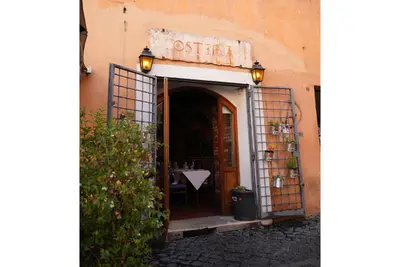 an entrance to a restaurant with a table in the doorway at C&A Apartments - Authentic Trastevere in Rome