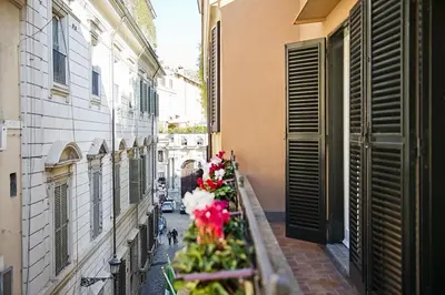 an alley with flowers on the side of a building at Domus Libera in Rome