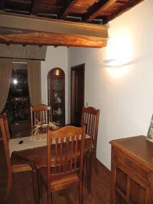 a dining room with a wooden table and chairs at Appartamento Benincampi in Rome