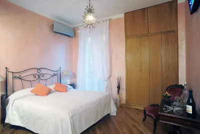 a bedroom with a bed with orange pillows on it at Sweet Dreams in St Peter B&b in Rome