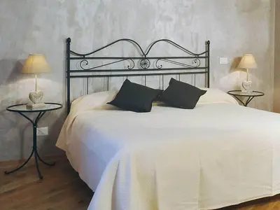 a bedroom with a large white bed with two tables at Sweet Dreams in St Peter B&b in Rome