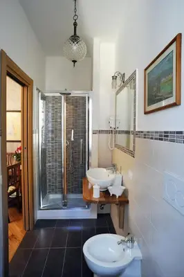 a bathroom with a sink and a toilet and a shower at Sweet Dreams in St Peter B&b in Rome