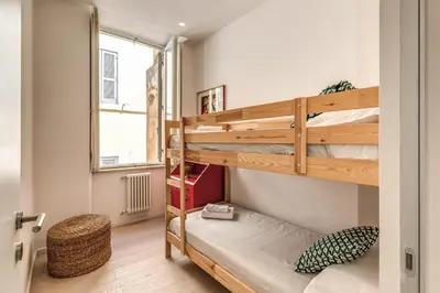 a room with two bunk beds and a window at Fresh House Fori Imperiali in Rome