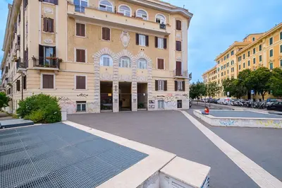 an empty street in front of a large building at ht la spezia bilo in Rome
