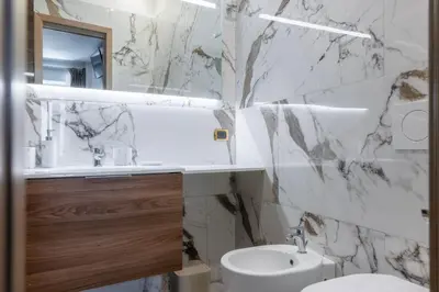 a white bathroom with a sink and a toilet at Angie's Dream Home - Spanish Steps Rome in Rome