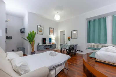 a living room with a couch and a table at Vicomoro House Trastevere in Rome