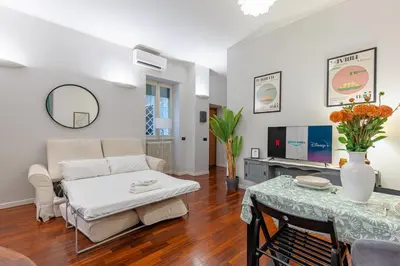 a living room with a couch and a table at Vicomoro House Trastevere in Rome