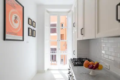 a kitchen with a bowl of fruit on a counter at iFlat Campo de' Fiori Brand New & Bright apt in Rome