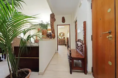 a hallway with a door and a potted plant at Luxury Trastevere Terraces in Rome