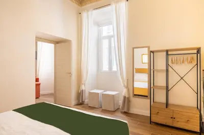 a bedroom with a bed and a mirror at Pantheon Apartments - Piccola Roma in Rome