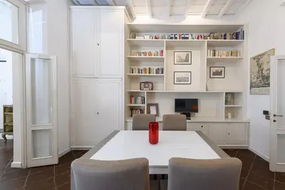 a white dining room with a white table and chairs at Bernini al Borgo in Rome