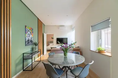 a living room with a glass table and chairs at iFlat Saint Peter Green Chic Brand New Apartment in Rome