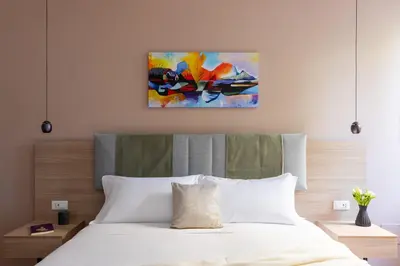 a bedroom with a bed and a painting on the wall at iFlat Saint Peter Green Chic Brand New Apartment in Rome