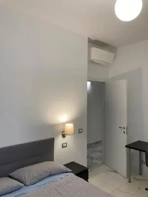 a bedroom with a bed and a table and a desk at Apartment Roma San Pietro in Rome