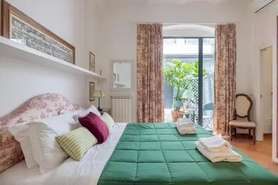a bedroom with a large bed with towels on it at Colosseum Charming Apartment in Rome