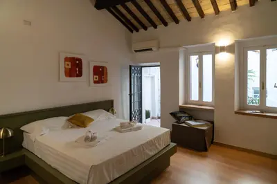 a bedroom with a bed with two towels on it at Romantic Suite nel Cuore di Roma - Piazza Navona - in Rome